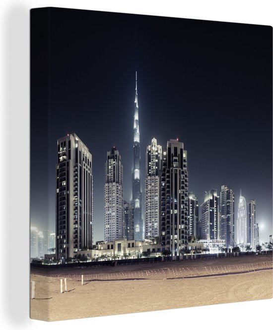 Canvas Schilderij De Burj Khalifa verlicht met andere wolkenkrabbers de lucht boven Dubai - Wanddecoratie