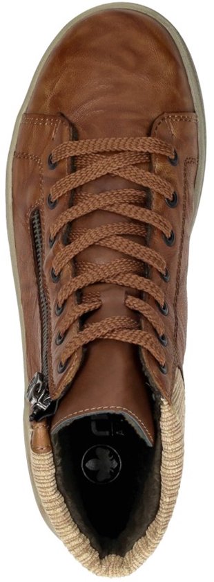 Bovenkant van een cognackleurige leren dames sneaker met rits en corduroy boord.