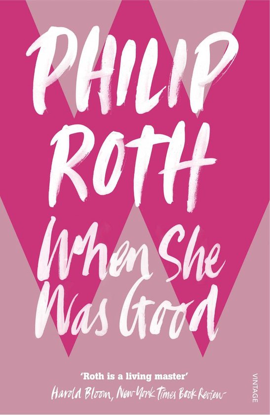 Boekcover van 'When She Was Good' van Philip Roth, met witte sierlijke letters op een roze en beige geometrische achtergrond.