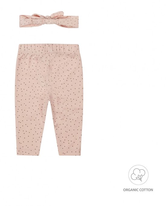 Roze legging met donkerbruine stippen en knoopjes.