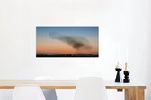 Canvas Schilderij Zwerm spreeuwen bij een kleurrijke zonsondergang - 80x40 cm - Wanddecoratie
