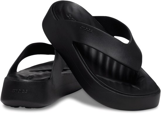 Paire de tongs compensées noires Crocs, la première est droite, la seconde est plate.