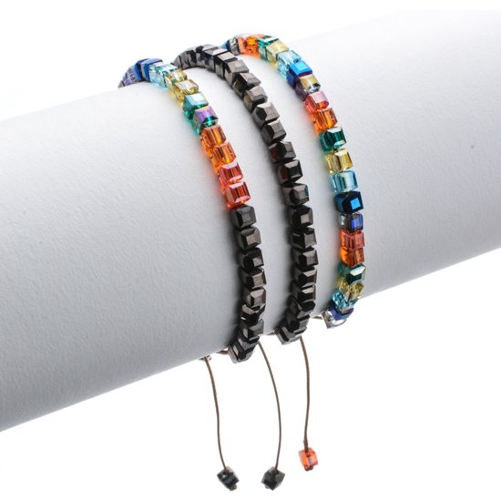 Drie verstelbare armbanden met vierkante kralen, gedrapeerd op een rol.