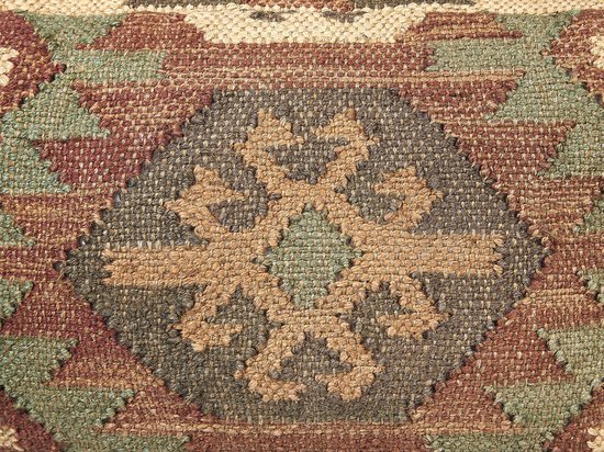 Detail van een poef met een geometrisch patroon en een centraal bloemmotief in beige, groen en roodbruin.