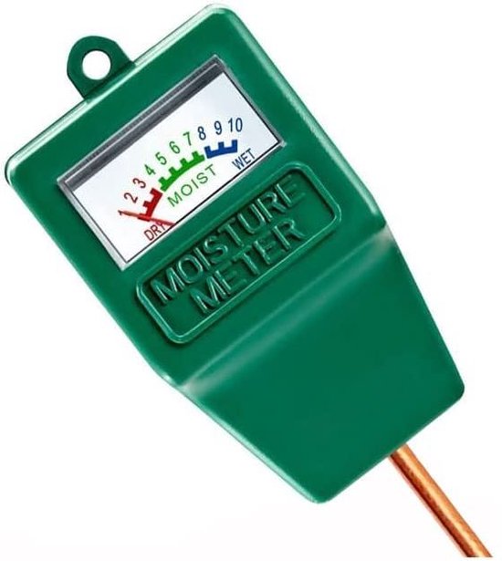 Detail van een groene vochtigheidsmeter met koperen pen en wijzerplaat.
