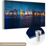 MuchoWow® Glasschilderij 80x40 cm - Schilderij acrylglas - Skyline van Willemstad in de avond in Curaçao - Foto op glas - Schilderijen