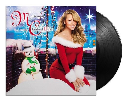 Mariah Carey, "Merry Christmas II You" albumhoes met vinylplaat. Mariah draagt een rode kerstjurk met witte bontafzetting.