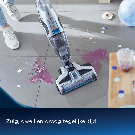 BISSELL Crosswave C3 Select stofzuiger met dweil veegt gemorste drank en confetti op tegelvloer.