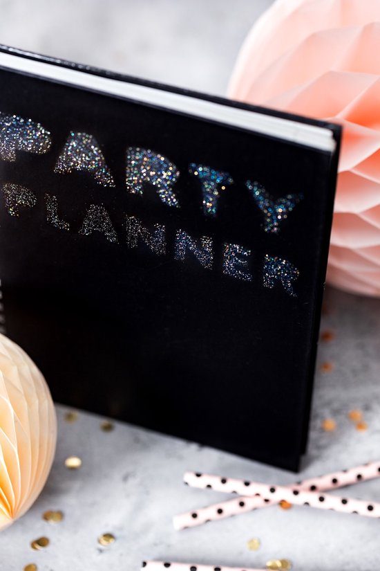 Carnet noir "PARTY PLANNER" avec des lettres recouvertes de particules de paillettes scintillantes.