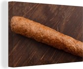 Tableau sur toile Un délicieux frikandel sur fond de bois - 150x100 cm - Décoration murale