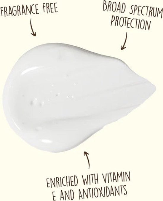 Une goutte de crème solaire blanche avec le texte "Fragrance Free" et "Broad Spectrum Protection".