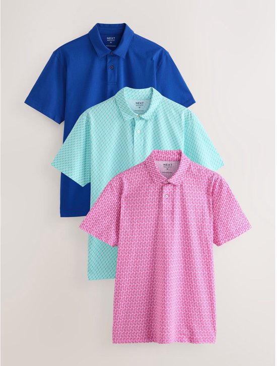 Drie poloshirts: effen blauw, mintgroen met geometrische print, roze met zeepaardjesprint.