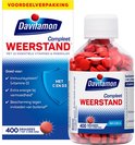 Glazen pot met 400 rode Davitamon Compleet Weerstand pillen. De pot zit naast de kartonnen verpakking.