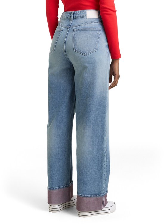 Achterkant van een wijde, lichtblauwe jeans met omgeslagen zoom en roze voering.