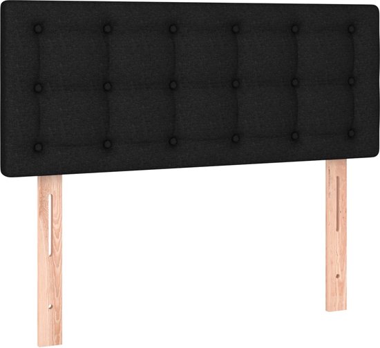 Tête de lit noire capitonnée avec montants de fixation en bois.