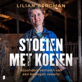 Lilian Bergman draagt een blauwe overall en heeft haar van achteren vastgebonden. Ze staat voor een stal met de tekst 'Stoeien met koeien'.