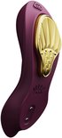 Vibrateur violet avec accent doré et logo de la marque.