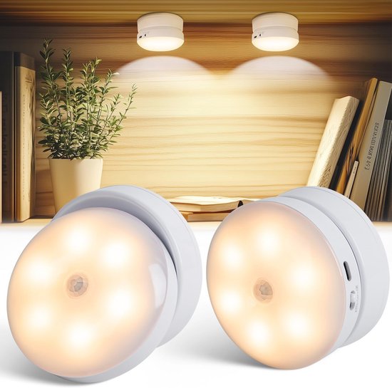 Twee witte, ronde LED-lampen met bewegingssensor op een plank.