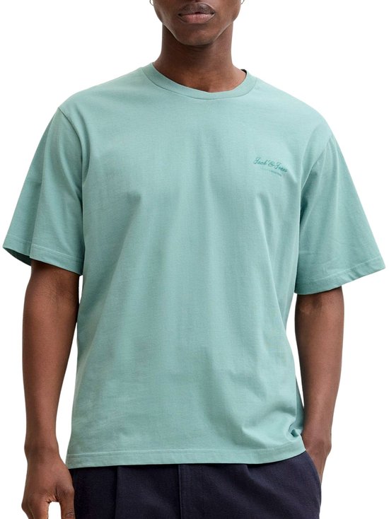 Man met donkerblauwe broek en lichtgroen T-shirt met korte mouwen, met opdruk 'Jack & Jones'.