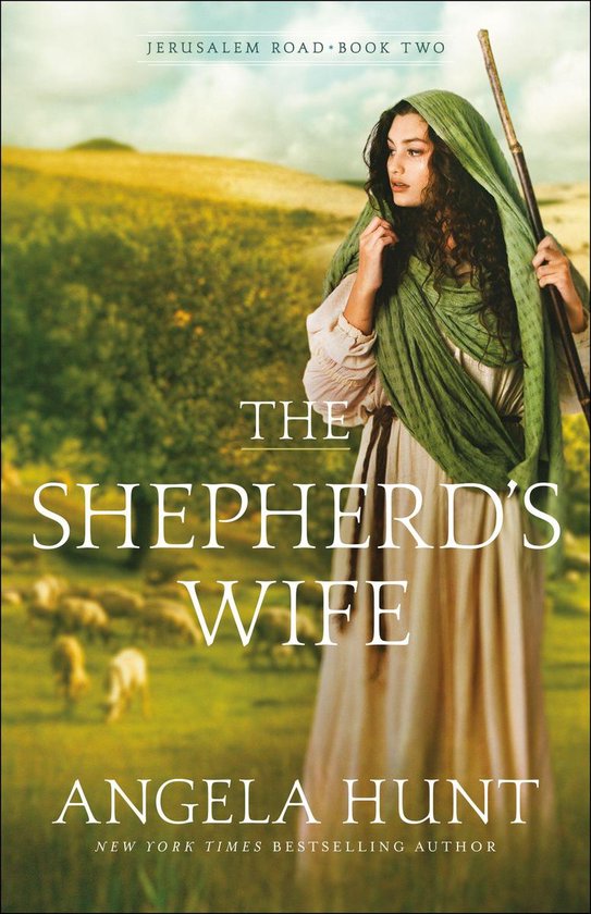Couverture du livre 'The Shepherd's Wife' avec une femme en robe longue et foulard vert, tenant un bâton de berger. Des moutons sont visibles à l'arrière-plan sur une colline.