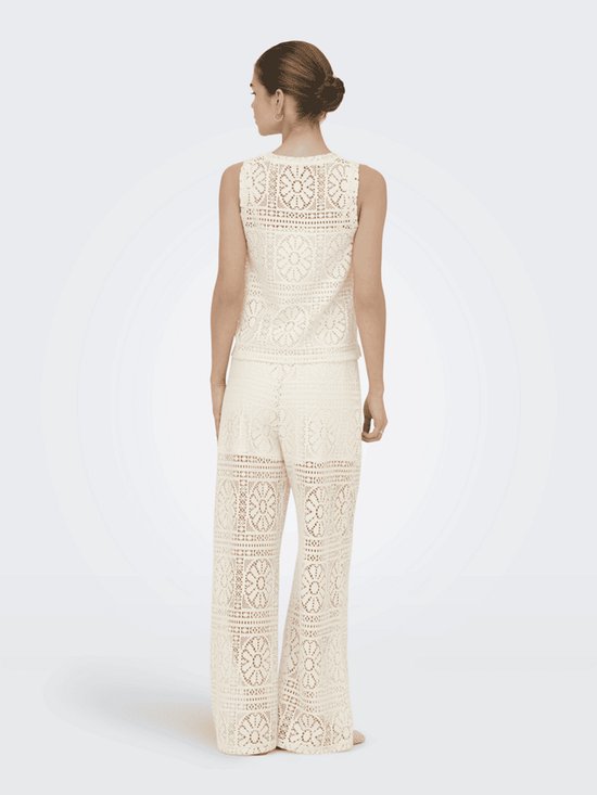 Achteraanzicht van een model met een bijpassende kanten top en broek met wijde pijpen in het crèmewit.