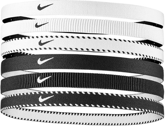 Zes Nike haarbanden, zwart en wit met het Nike logo. Sommige met ribbels, andere met stippen.