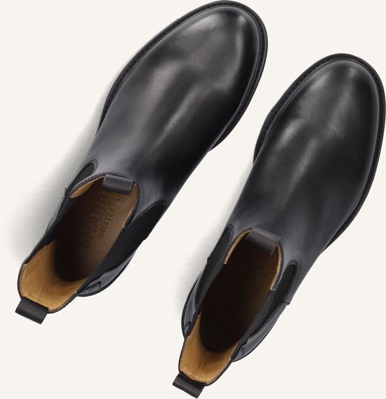 Paar zwarte leren Chelsea boots, van bovenaf gezien, met de binnenkant zichtbaar.