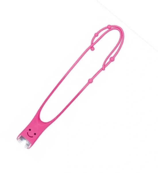 Roze leeslampje met gezichtje, op de grond.