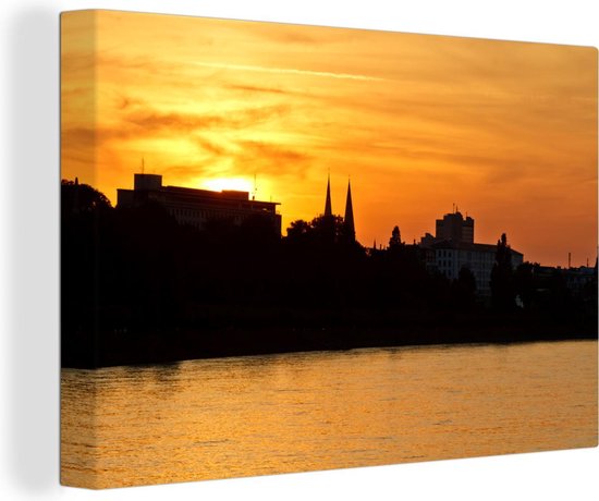 Canvas Schilderij Oranje lucht boven Bonn door de zonsondergang - 60x40 cm - Wanddecoratie