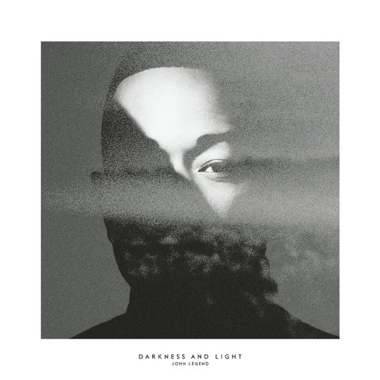 Albumhoes 'Darkness and Light' van John Legend, met een zwart-wit portret van de zanger wiens gezicht gedeeltelijk bedekt is met rookachtig effect.