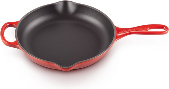 Kersrode gietijzeren koekenpan met steel en twee lussen, van bovenaf gezien op een witte achtergrond.