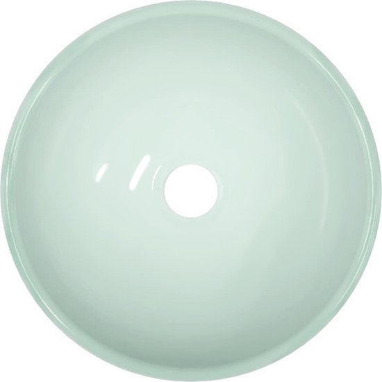 Lavabo rond vert clair, vu de dessus.