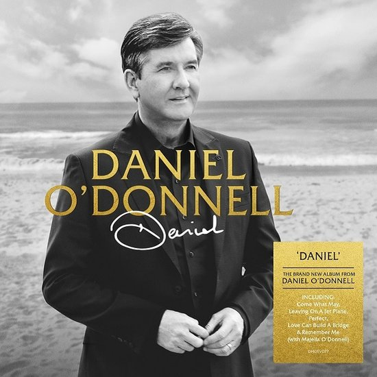 Album "Daniel" met Daniel O'Donnell op een strand, met een gouden sticker met albumdetails.
