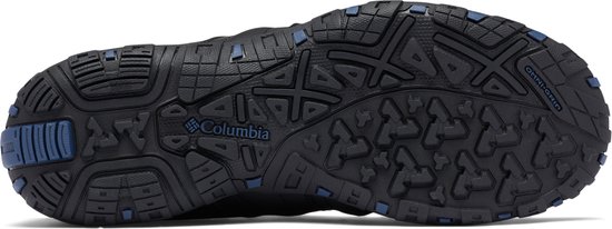 Zool van een zwarte wandelschoen met blauwe rubberen noppen en Columbia-logo.