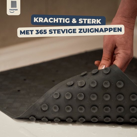 Grijs douchemat op de grond, met zuignappen zichtbaar.