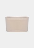 Naadloze bandeau-bh in een nude kleur.