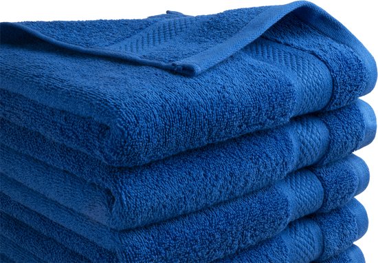Gros plan sur des serviettes bleu classique empilées avec un motif en losange sur le bord.