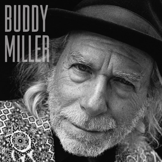 Portret van Buddy Miller met hoed en gedessineerd jasje.