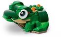 Een groene legokikker met grote blauwe ogen, zittend op een licht beige onderstel en met oranje details.