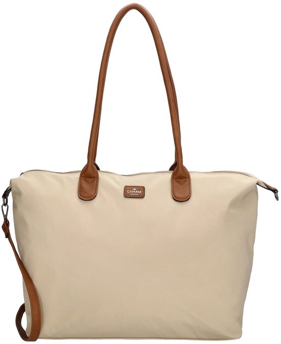 Grote beige tas met bruine hengsels en een afneembare schouderband. Op de tas een subtiel patroon van witte stippen en een logo.