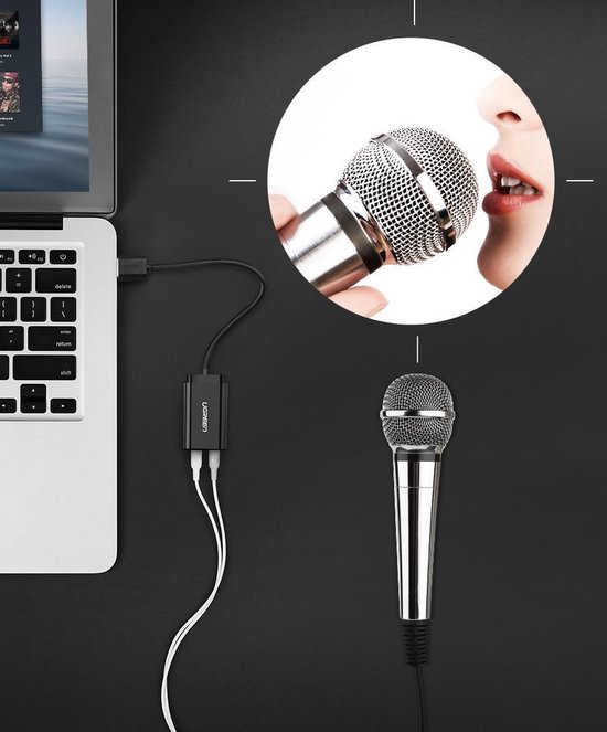 Zwarte UGREEN USB geluidskaart adapter aangesloten op laptop met microfoon.