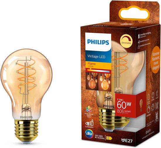 Lampe LED Vintage Philips à côté de son emballage. La lampe a un culot E27 et un verre ambré avec filament en spirale.