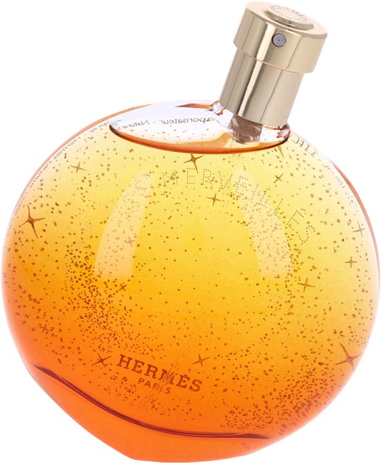 Oranje parfumfles met gouden dop, versierd met glinsterende sterren en stipjes.