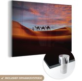 MuchoWow® Glasschilderij 60x40 cm - Schilderij acrylglas - Kamelen - Man - Zonsondergang - Foto op glas - Schilderijen