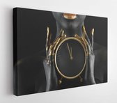 Canvas schilderij - Beautiful woman with black and golden paint on her body holding clock against dark background, closeup -     1195012684 - 80*60 Horizontal