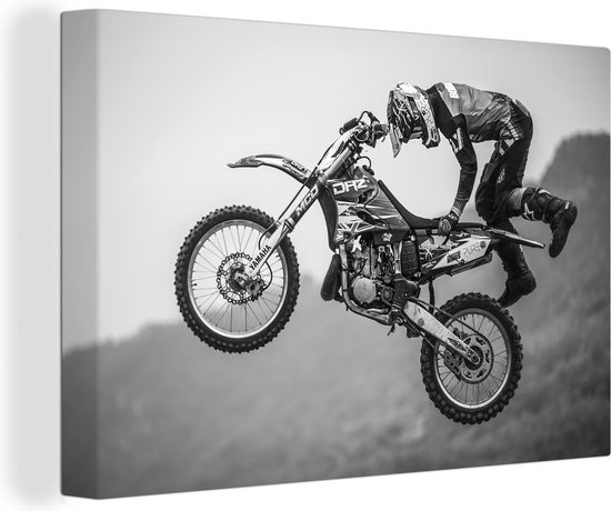 Canvas Schilderij Stunt in de lucht met een motor in zwart-wit - 120x80 cm - Wanddecoratie