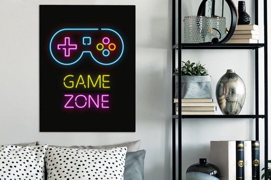 Panneau néon avec un joystick et le texte 'GAME ZONE' en bleu, jaune et rose, au-dessus de coussins sur un canapé.