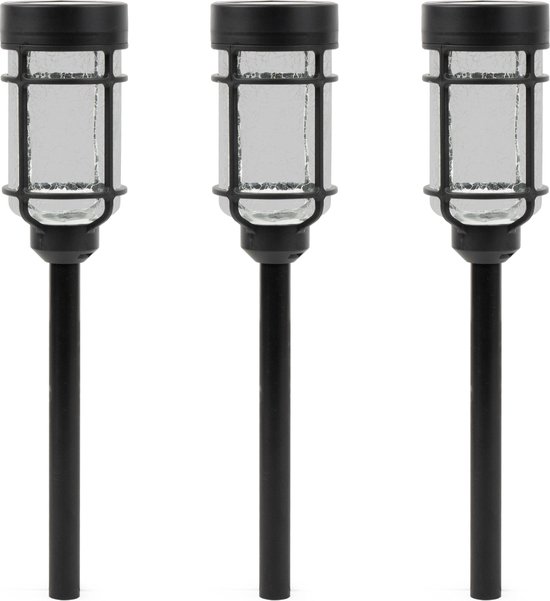 Drie zwarte solar tuinlampen met een cilindrisch, geribbeld glazen kapje en een zwarte dop.