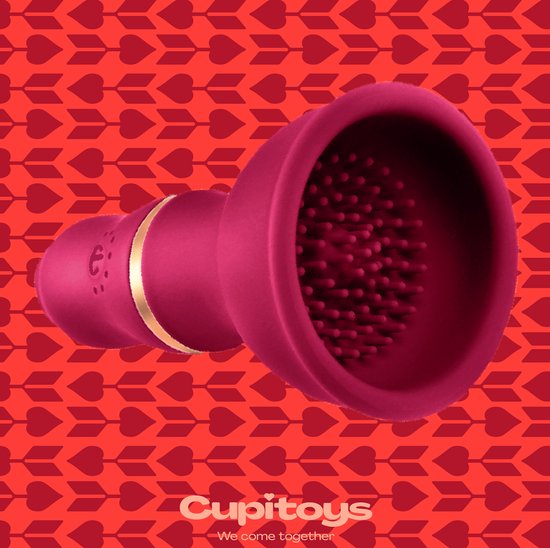 Bordeauxrode vibrator met gouden ring, getoond op een achtergrond van harten en pijlen.