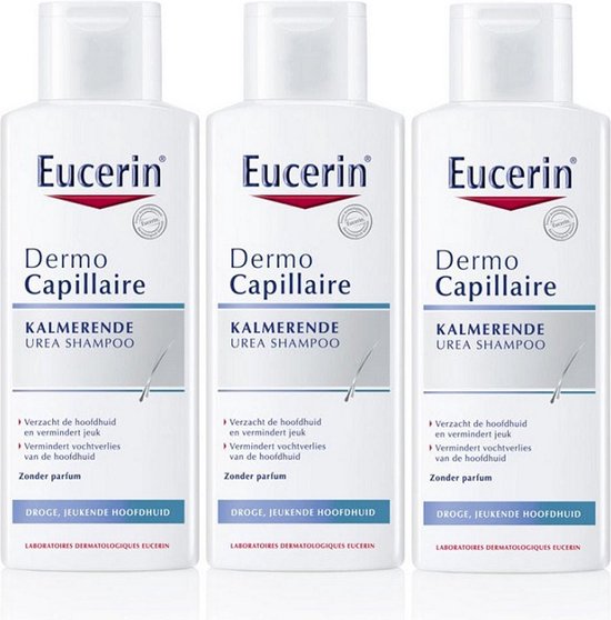 Drie Eucerin DermoCapillaire Kalmerende Urea Shampooflessen, wit met rode en grijze tekst.